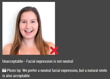Passport photo example with expression that may be unacceptable (China (中国) — Visa (2x2 inch) ID photo guide)